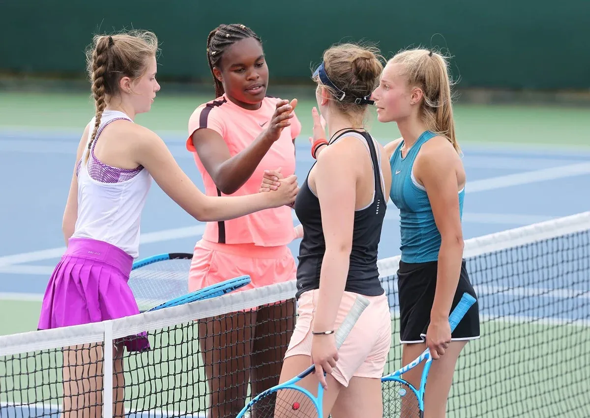 Girls doubles players handshake